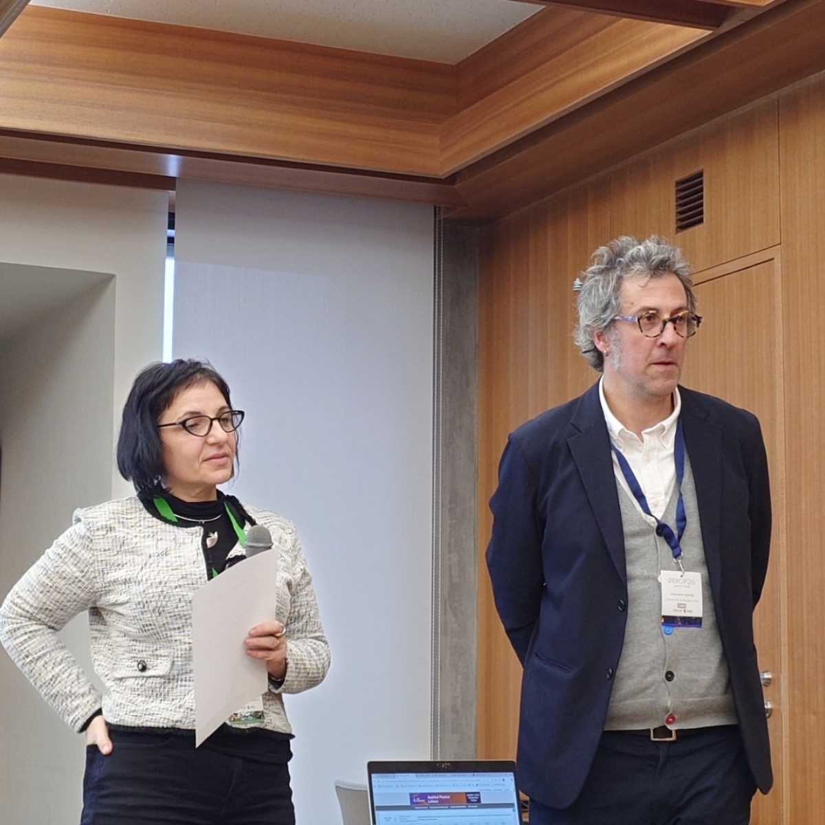 A man and woman standing in a room.