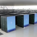 Rows of Fujitsu Fugaku supercomputer racks inside a large high-performance computing data centre.